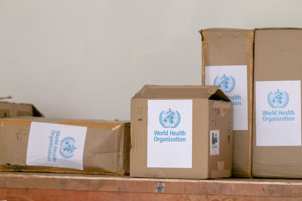 cardboard boxes with world health organization sticker